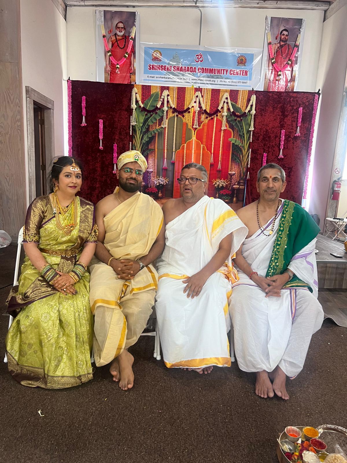 Devotees in traditional attire in front of the altar