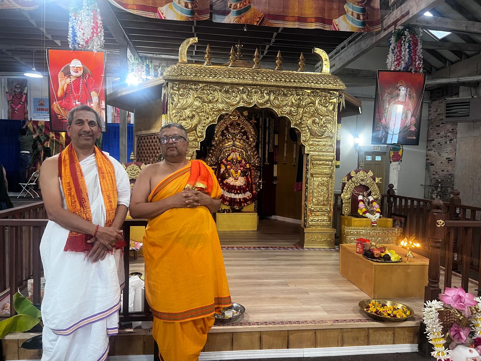 Two priests standing in front of the sanctum